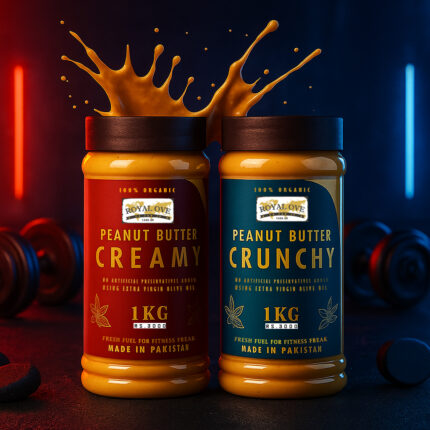 Two jars of Royal Ove peanut butter—one creamy and one crunchy—stand side by side on a dark surface, with peanut butter splashing dramatically out of the open lids. The creamy jar has a red label, and the crunchy jar has a blue label. Both “100% Organic,” “1KG,” and “Made in Pakistan.” The background features moody red and blue lighting with gym-style dumbbells, giving a bold, energetic fitness-themed look.