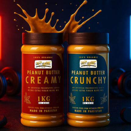 Two jars of Royal Ove peanut butter—one creamy and one crunchy—stand side by side on a dark surface, with peanut butter splashing dramatically out of the open lids. The creamy jar has a red label, and the crunchy jar has a blue label. Both “100% Organic,” “1KG,” and “Made in Pakistan.” The background features moody red and blue lighting with gym-style dumbbells, giving a bold, energetic fitness-themed look.